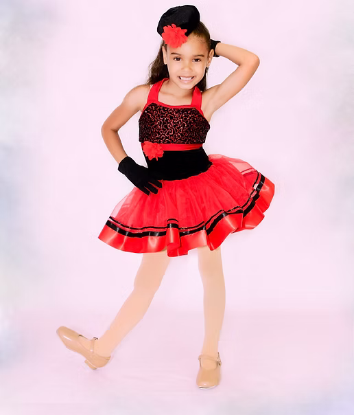 Young dancer in a red and black recital costume